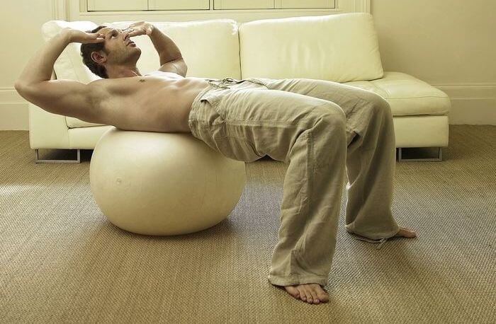 Man exercising in his home.